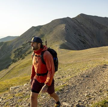 a man enjoying a day hike in the scenic mountains of montana.