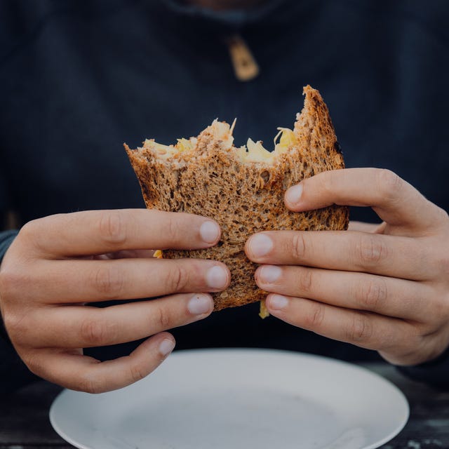 man enjoying grilled sandwich