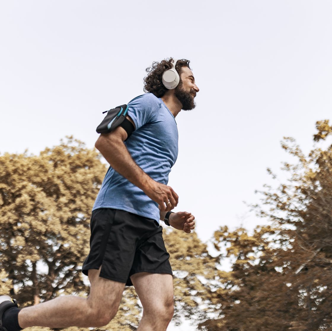 man enjoying music while jogging in scenic nature