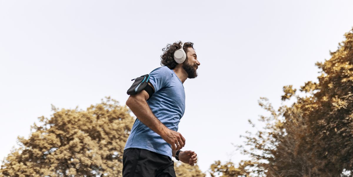 man enjoying music while jogging in scenic nature