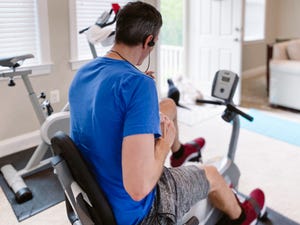 man exercises at home during pandemic on a recumbent bike, recumbent bike benefits