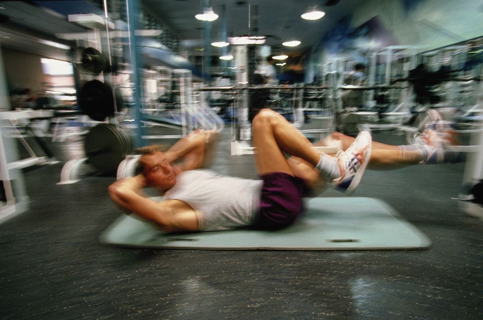 man exercising in gym blurred motion