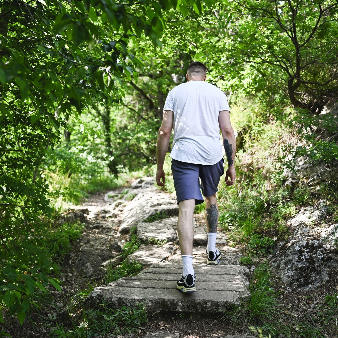 man exercising in woodland.