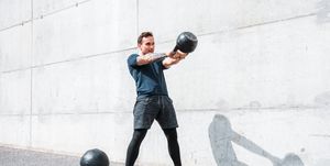 Man exercising with a kettlebell outdoors
