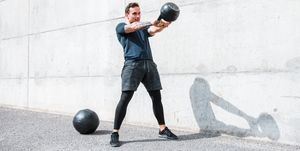 Man exercising with a kettlebell outdoors
