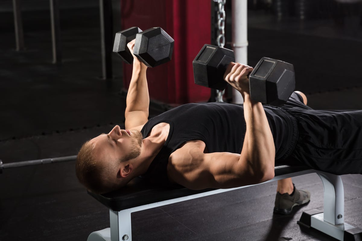 https://hips.hearstapps.com/hmg-prod/images/man-exercising-with-dumbbell-royalty-free-image-915447278-1545444769.jpg?crop=1.00xw:0.752xh;0,0.0913xh&resize=1200:*