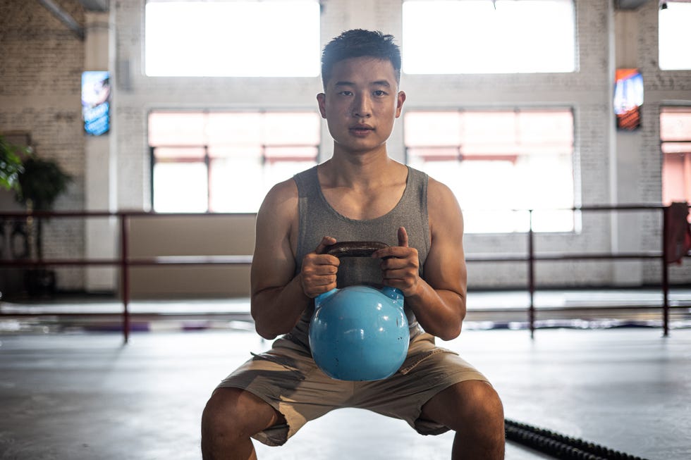 man exercising with kettlebell