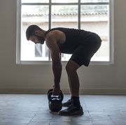 man exercising with kettlebells, cross training concept
