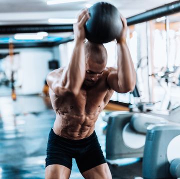 Man exercising with medicine ball in the gym