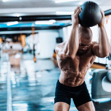 Man exercising with medicine ball in the gym
