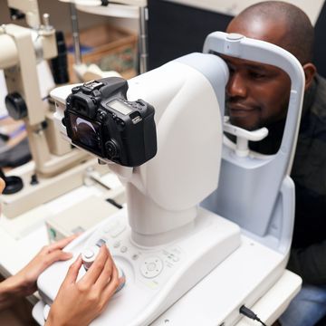 man, eye exam and refractometer at ophthalmologist clinic with help for healthcare, process and results for vision african patient, machine and test for eyesight, tech and consultation in hospital