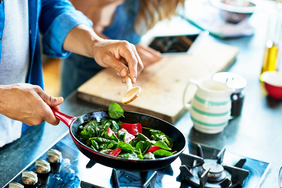 man frying vegetables