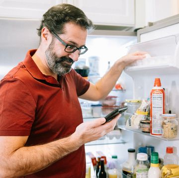 man gets ingredients from the fridge