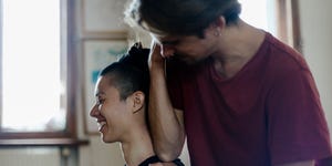 man giving girlfriend sports massage at home