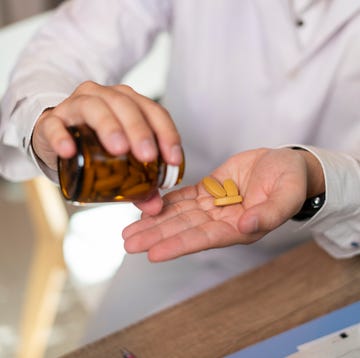 man hand taking medicine