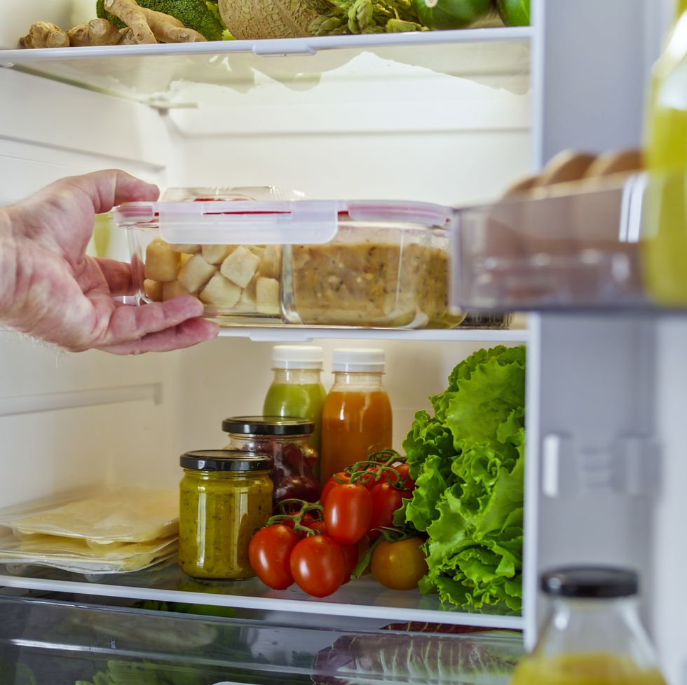 man hands taking food out of refrigerator