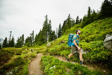 man hiking on mountain trail