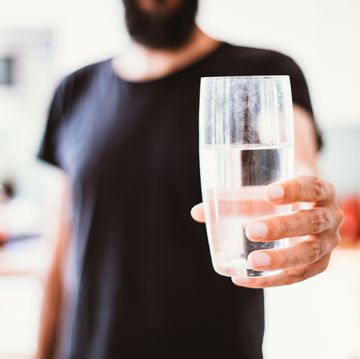a man holding a glass of water