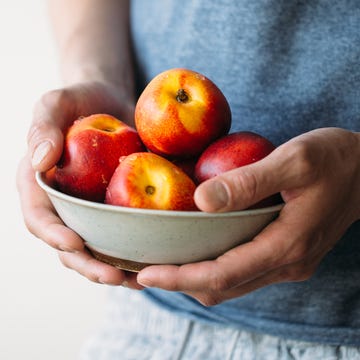 man holding fresh peaches summer healthy food concept