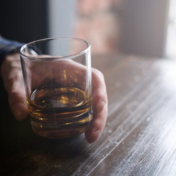 Man holding glass of whisky Man holding glass of whisky