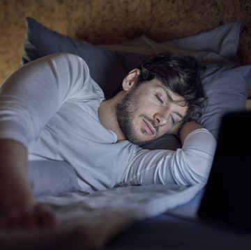 man in bed with computer