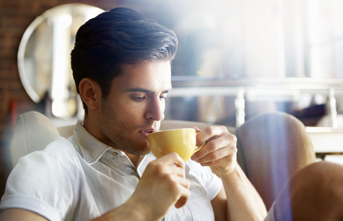 man in cafe drinking coffee
