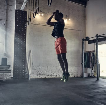 Man in gym jumping in mid air