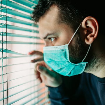 man in lockdown looking through the window