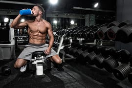 man in the gym drinking protein shake drink