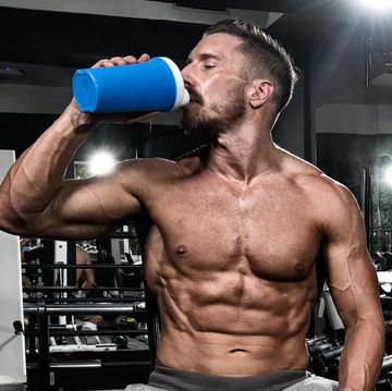 man in the gym drinking protein shake drink