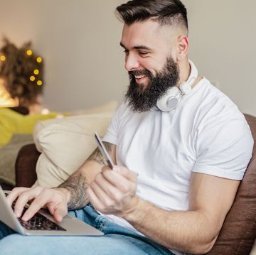 man using card for online shopping at home