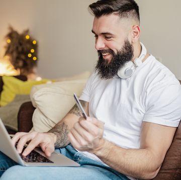 man using card for online shopping at home