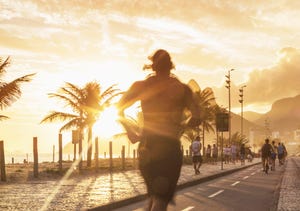 man jogging on the beach of ipanema at sunset