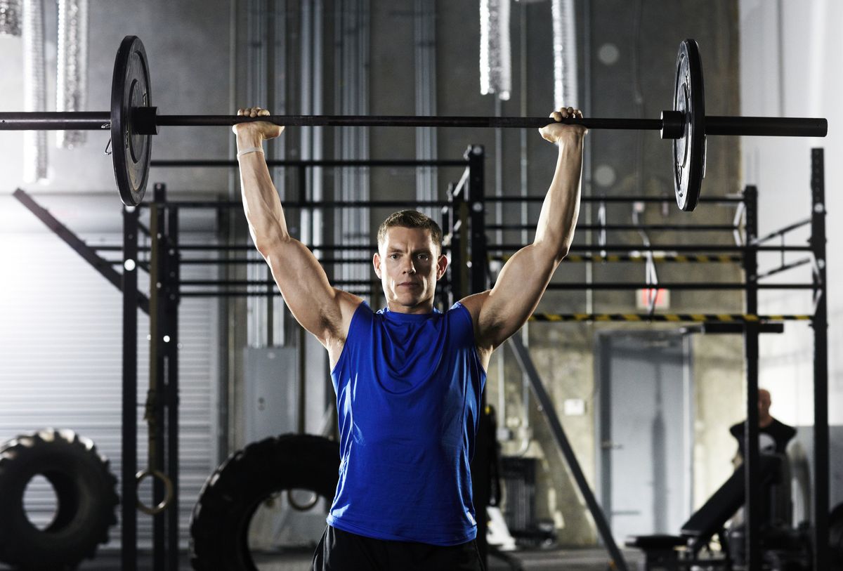 Man lifting barbell above his head