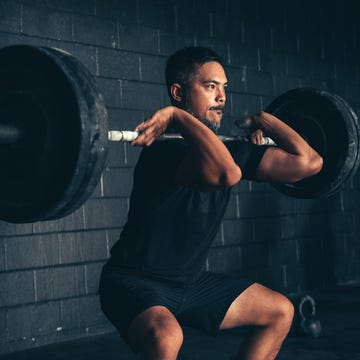 man lifting barbell in gym