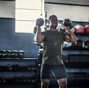 daily undulating periodization   man lifting dumbells at cross training gym