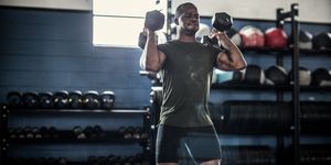 man lifting dumbells at cross training gym