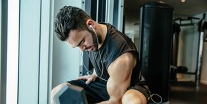 man lifting weights in gymnasium