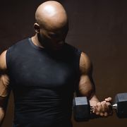 man lifting weights, studio shot