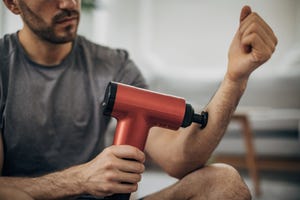 man massaging his arm