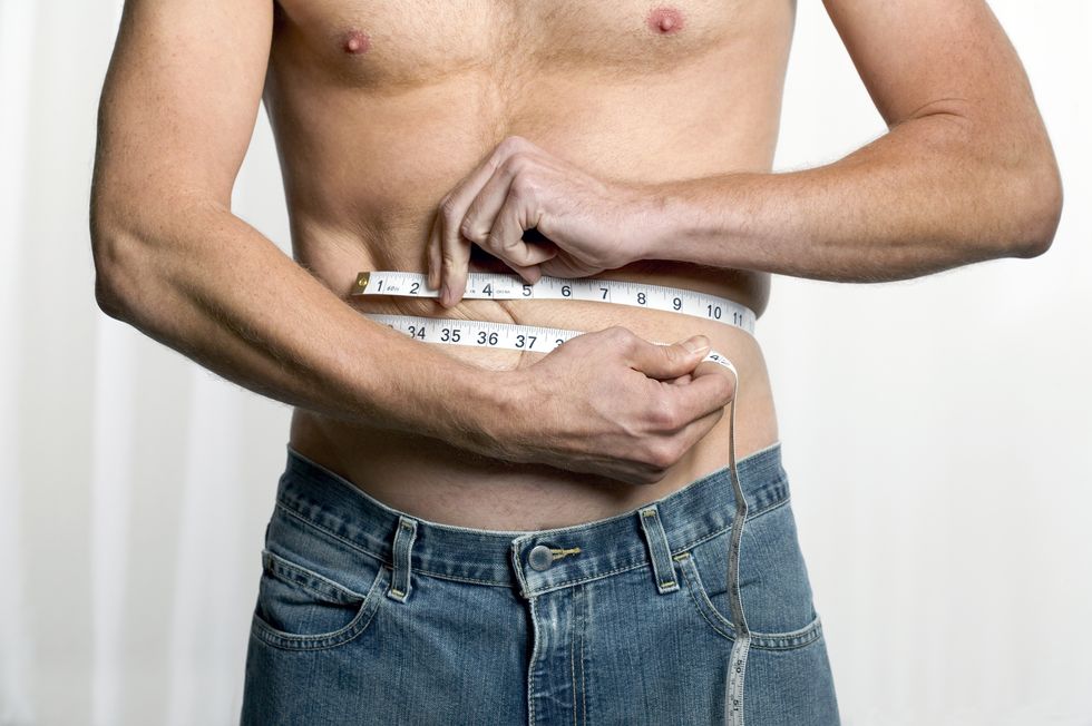 Man measuring his waistline