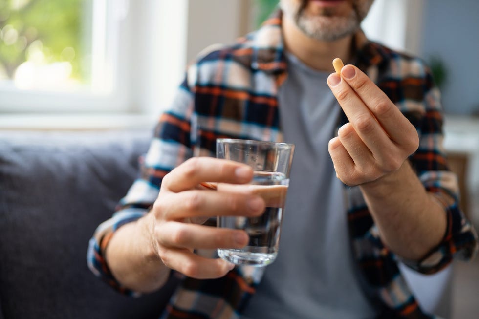 man medicating himself at home