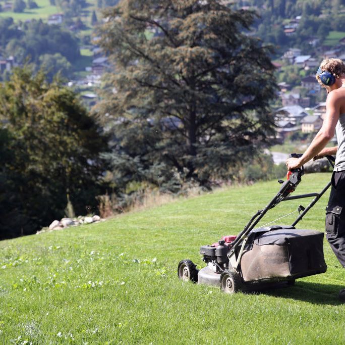 https://hips.hearstapps.com/hmg-prod/images/man-mowing-the-lawn-france-news-photo-924736142-1548174420.jpg?crop=0.668xw:1.00xh;0.332xw,0&resize=1200:*