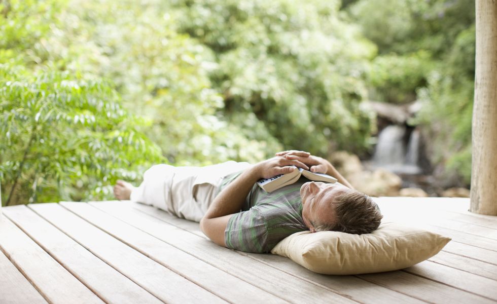 man napping on porch in remote area