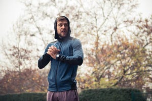 cropped shot of an athletic man taking a break from his run