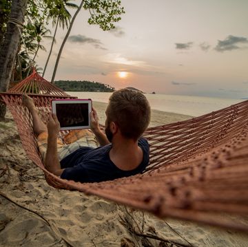Man on hammock relaxing-Digital tablet