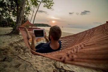 Man on hammock relaxing-Digital tablet