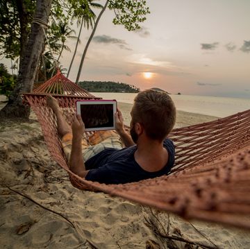 Man on hammock relaxing-Digital tablet
