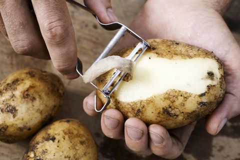 man peeling potato