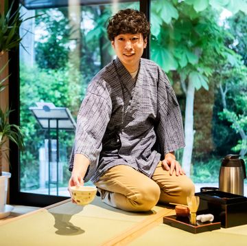 a man prepares for a tea ceremony experience for tourists visiting japan